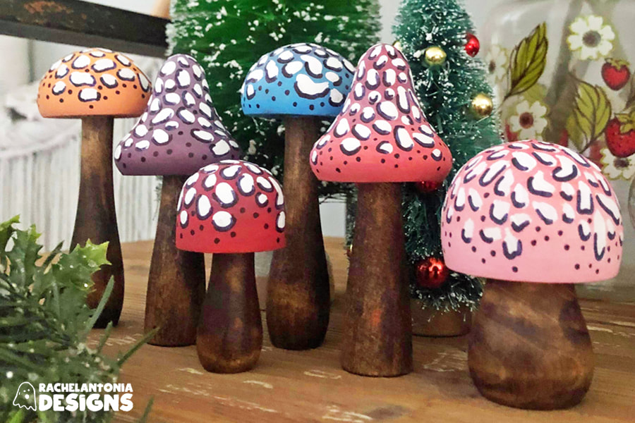 Image of different size and shape wood mushrooms hand painted in different colors