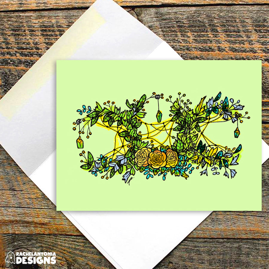 Image of a card on a green background with a detailed triple moon wreath made of flowers