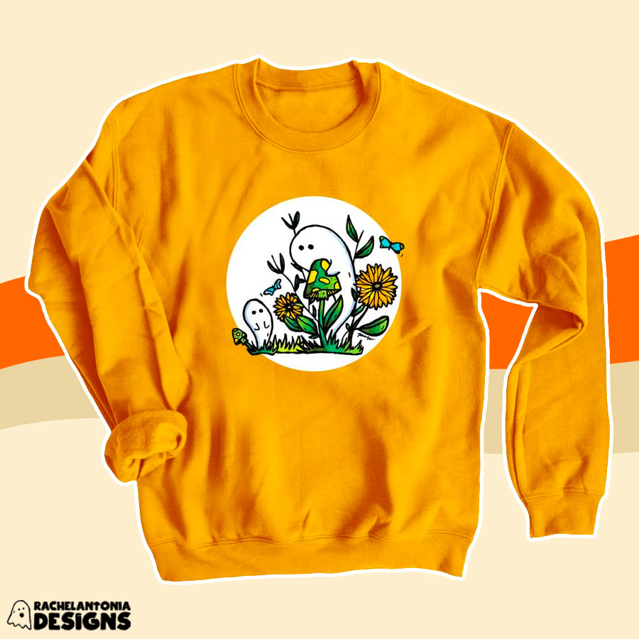 Photo of a gold sweatshirt with two ghosts mushrooms and flowers on it