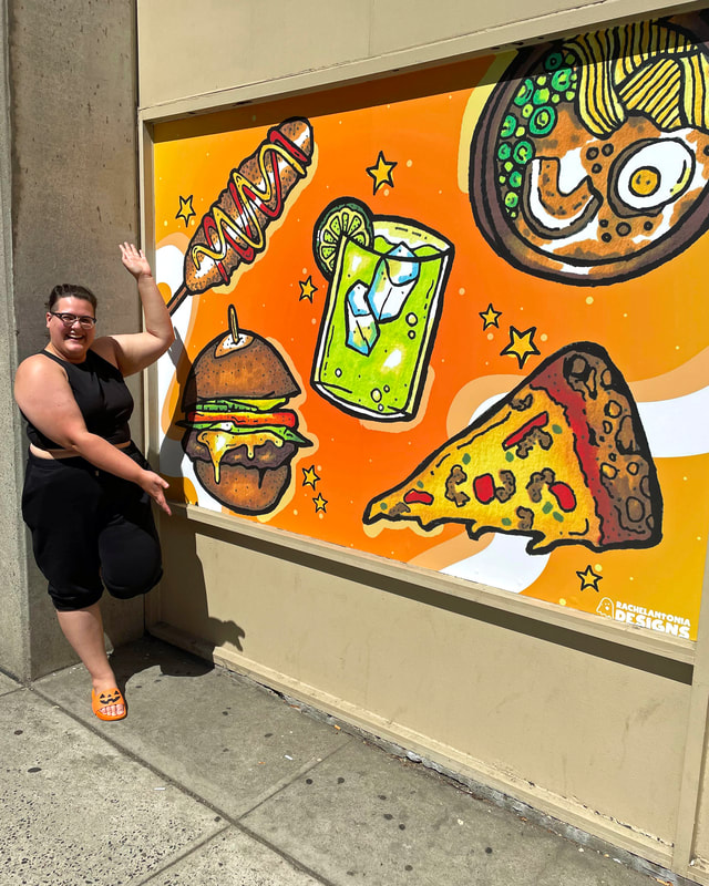 Rachel standing next to her food mural in New Haven